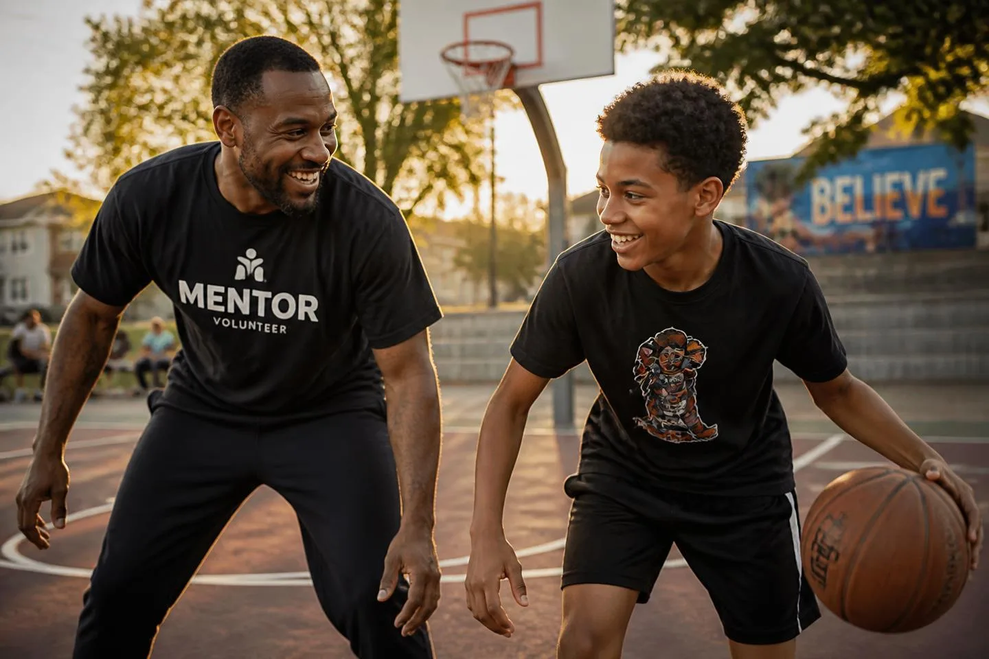 A mentor and a teenager playing basketball together